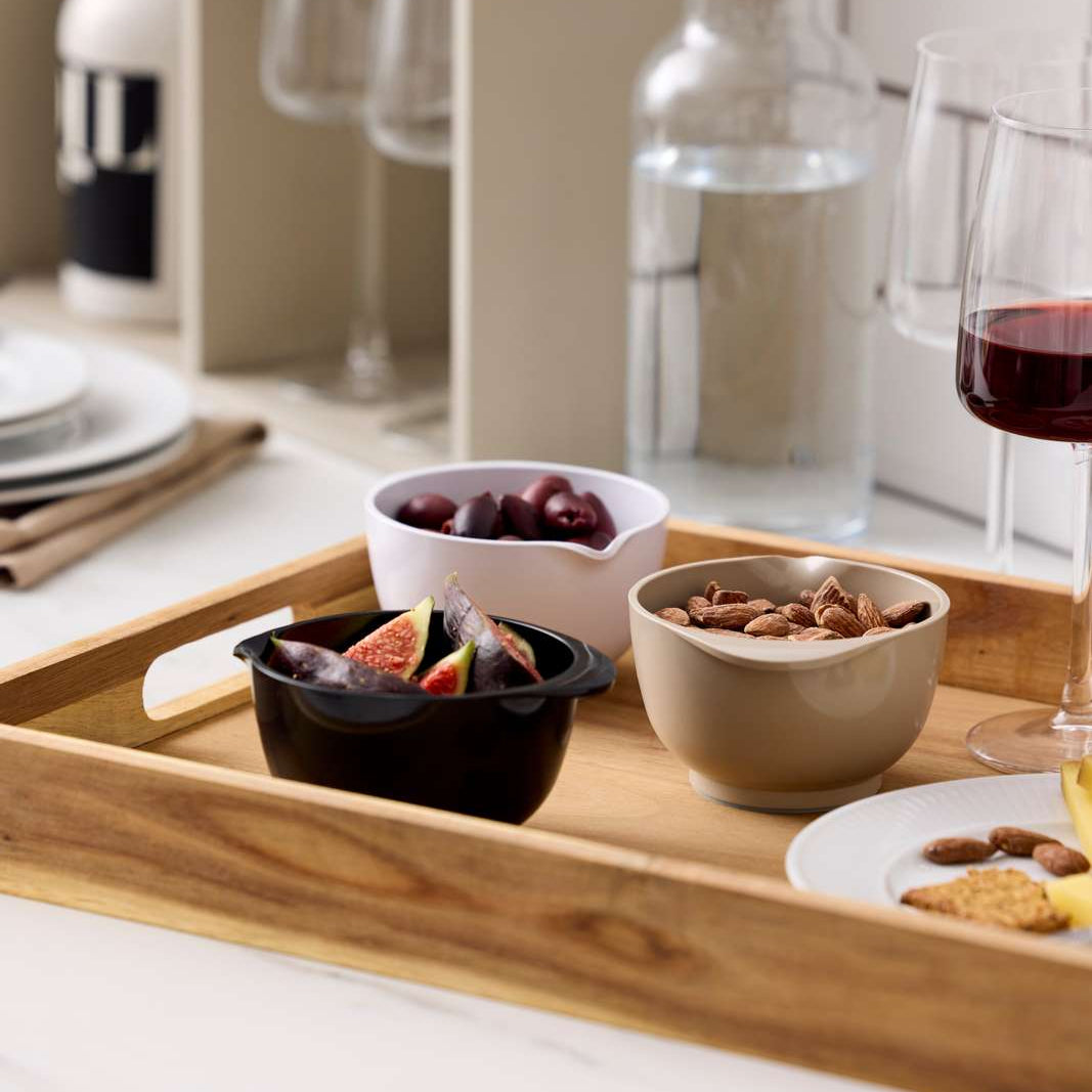 Wooden tray with snacks and drinks on a kitchen counter