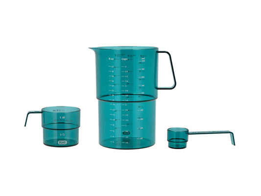 Set of teal measuring cups and jugs with handles on a white background